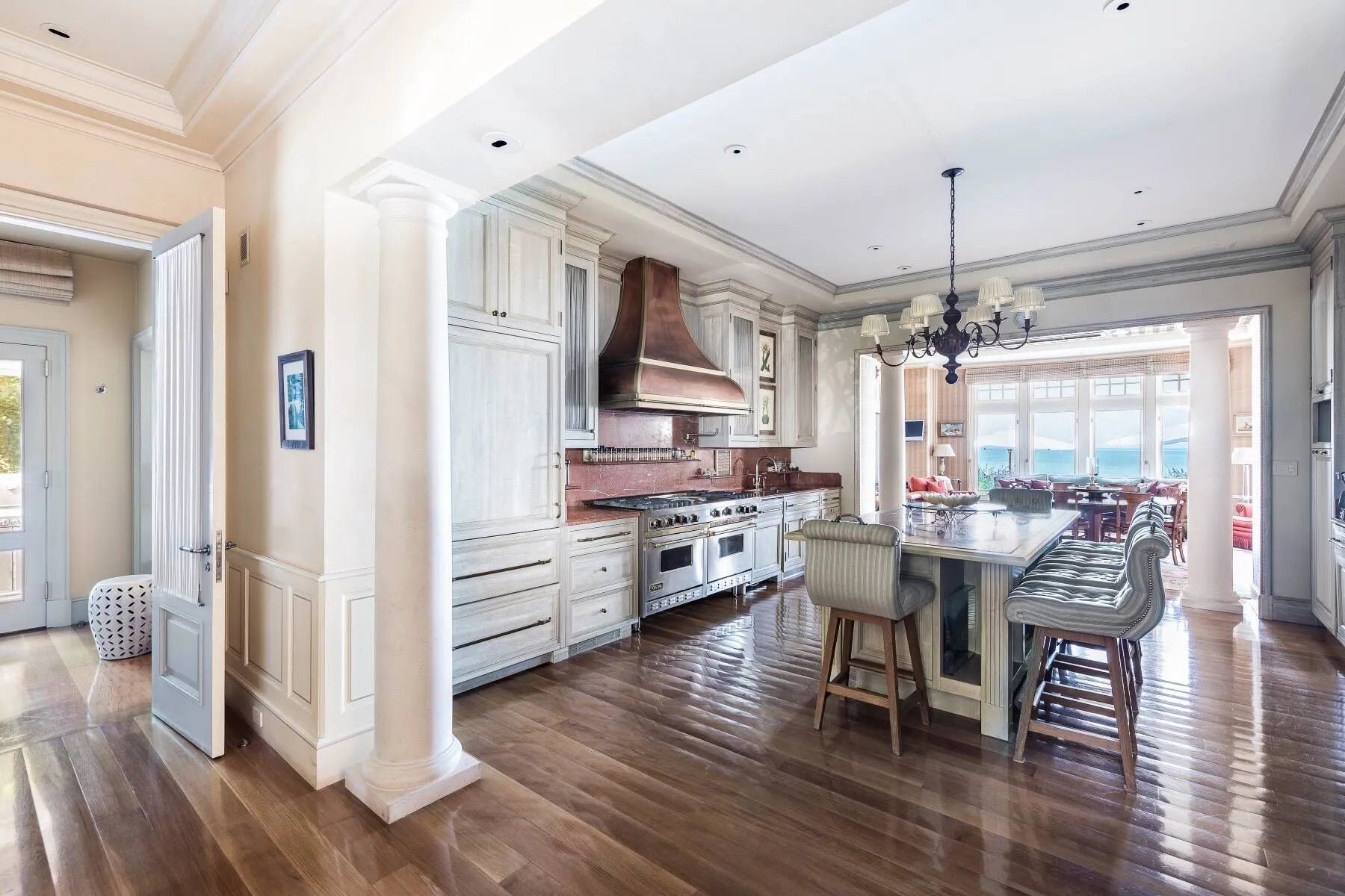 Bright, airy Hamptons interior with pristine marble kitchen and ocean-view windows