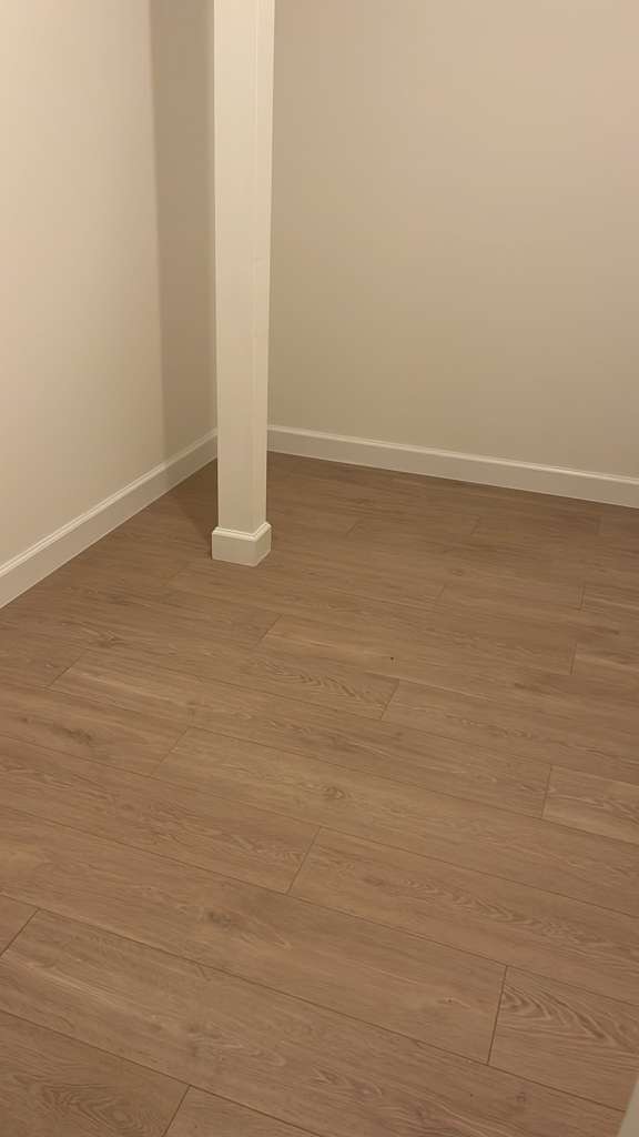 Empty bedroom floor cleaning by Long Island Maids