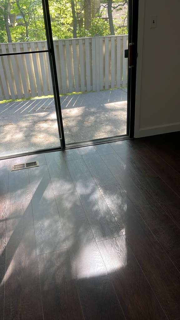 Post-construction floor cleaning near sliding door on Long Island